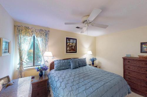 a bedroom with a bed and a ceiling fan at 443 Oceanwood Cottage in Kiawah Island