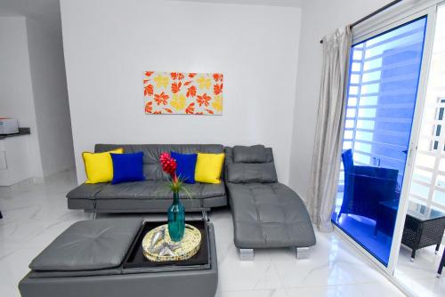a living room with a couch and a table at Rosil Place in San Felipe de Puerto Plata