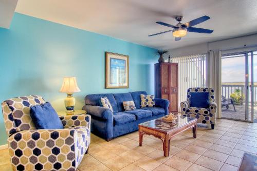 a living room with a couch and two chairs at Puente Vista 119 in Padre Island