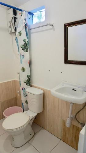a bathroom with a toilet and a sink at Mabuhay Thresher Dive Resort in Malapascua Island