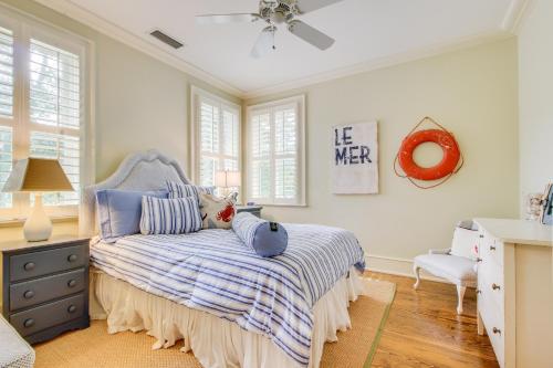 a bedroom with a bed with a blue and white bedspread at Camellia Villa in Saint Simons Island