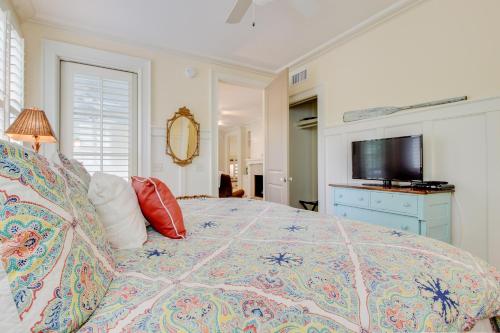 a bedroom with a large bed and a television at Camellia Villa in Saint Simons Island