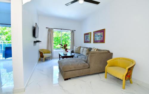 a living room with a couch and a chair at Rosil Place in San Felipe de Puerto Plata