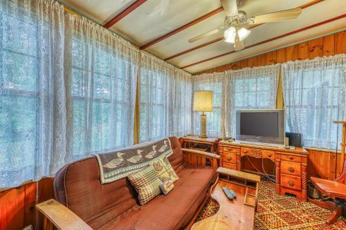 a living room with a couch and a television at Hunerburg White House in Chestertown