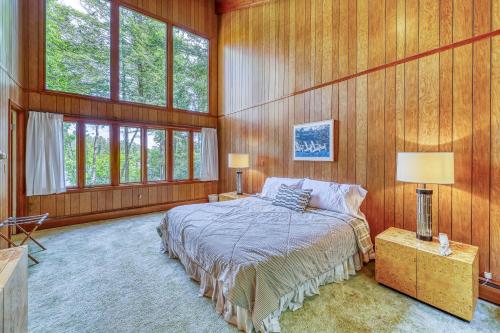 a bedroom with wood paneling and a bed and windows at Private Contemporary in Chestertown