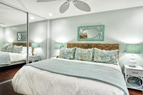 a bedroom with a large bed and a mirror at North Beach C in San Clemente