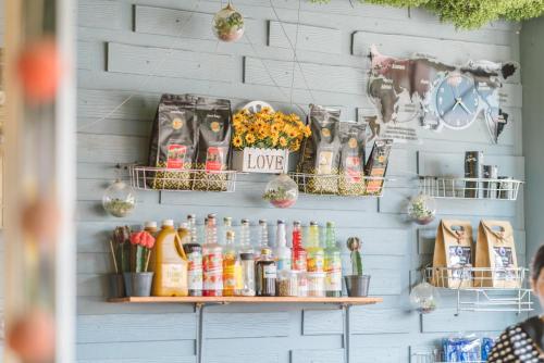 a wall with shelves filled with food and drinks at Pan's Place in Vang Vieng