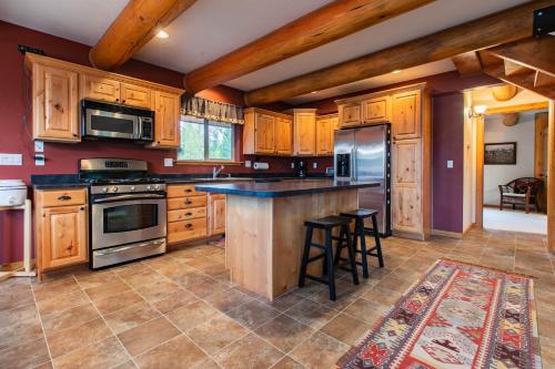 a kitchen with wooden cabinets and a counter top at Lake 5 Cabin in West Glacier