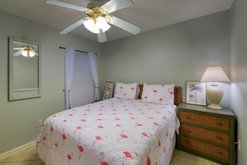 a bedroom with a bed and a ceiling fan at Phoenix Seabird in Romar Beach