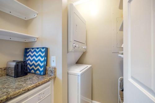a small kitchen with a refrigerator and a counter at Best Beach Spot in Myrtle Beach
