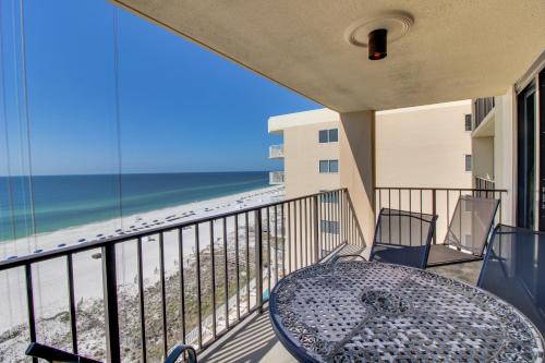 a balcony with a table and a view of the beach at Phoenix Seabird in Romar Beach