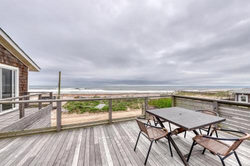 a patio with a table and chairs on a deck at 37 Ocean Bay Blvd in Ocean Bay Park