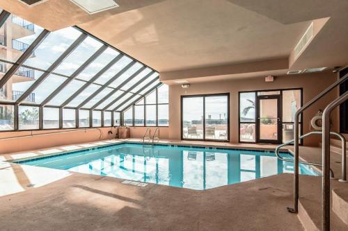 a swimming pool in a building with a glass ceiling at Four Seasons 501W in Orange Beach
