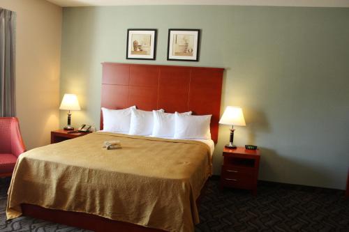 a hotel room with a bed and two lamps at Quality Inn Southampton in Southampton