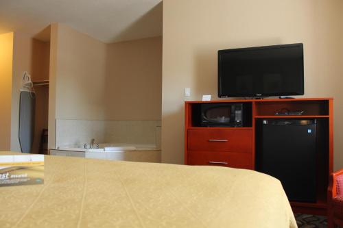 a hotel room with a television on top of a dresser at Quality Inn Southampton in Southampton