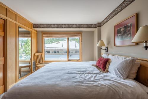 a bedroom with a large bed and a window at Shoshone 1960 in Big Sky