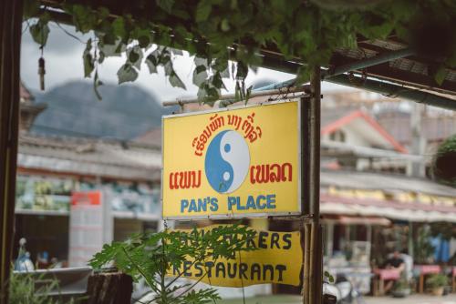 a yellow sign for a paris place at Pan's Place in Vang Vieng