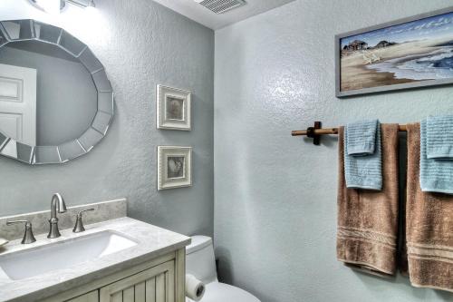 a bathroom with a sink and a mirror at North Beach C in San Clemente