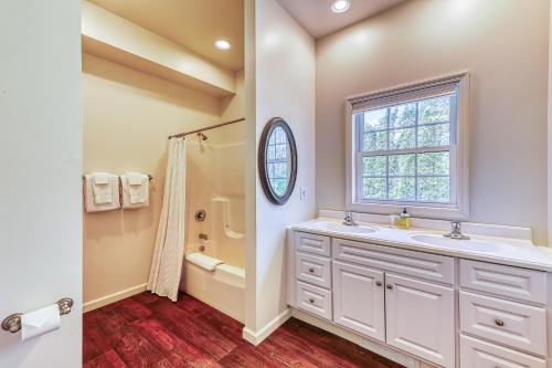 a bathroom with a sink and a shower and a window at Pine's Way Camp in Chestertown