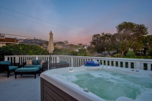 a jacuzzi tub on a deck with a patio at Ola Vista in San Clemente