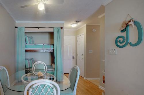 a dining room with a glass table and chairs at Best Beach Spot in Myrtle Beach