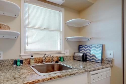 a kitchen with a sink and a window at Best Beach Spot in Myrtle Beach