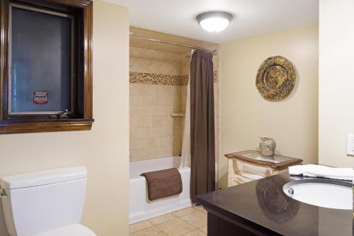 a bathroom with a toilet and a sink and a tub at 468 Pequawket Drive in Conway