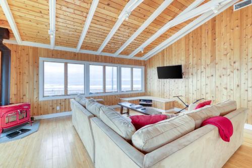 a living room with a large couch and a television at 37 Ocean Bay Blvd in Ocean Bay Park