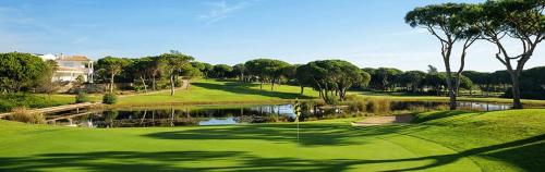 a view of a golf course with a pond at Casa Margarida Azul in Silves