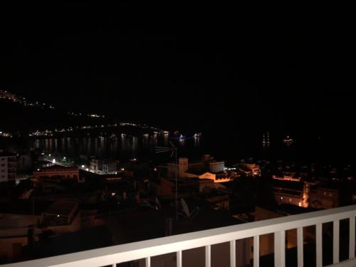 a view of a city at night at Taormina Wonderful Solarium in Giardini Naxos