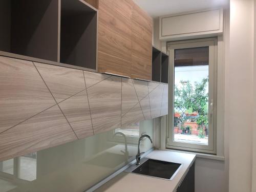 a kitchen with a sink and a window at Taormina Wonderful Solarium in Giardini Naxos
