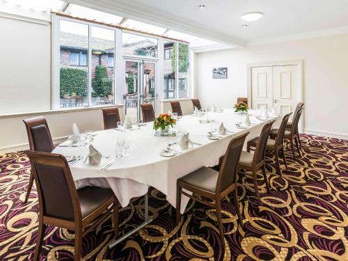 a large room with a long table and chairs at Mercure Dartford Brands Hatch Hotel & Spa in Ash