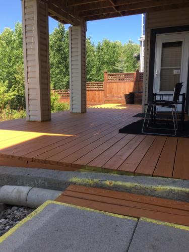 a porch with a deck with a chair on it at 民宿Ann's House in Calgary in Calgary