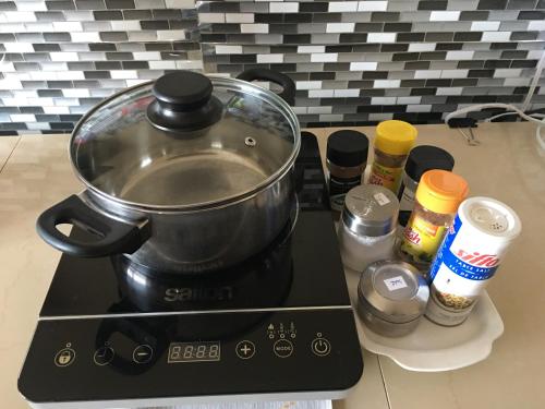 a pot sitting on top of a stove with spices at 民宿Ann's House in Calgary in Calgary