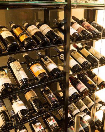 a bunch of wine bottles on a shelf at Phoenix Hotel by HHG in Hakuba