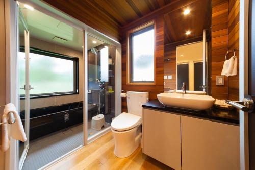 a bathroom with a sink and a toilet at WAGAYA by Hakuba Hotel Group in Hakuba