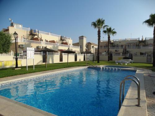 a large swimming pool in front of a building at Apartment Rayo Dorado in Orihuela Costa