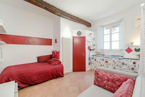 a bedroom with a red bed and a kitchen at Red Passion in Cernobbio