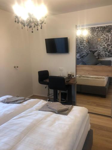 a bedroom with a bed and a desk and a mirror at Enjoyit Velden West in Selpritsch