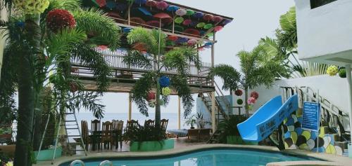 a resort with a swimming pool and a pool slide at Sascha's Resort Oslob in Oslob