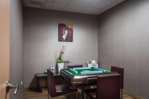 a dining room with a table and chairs in a room at Shianghu Boutique Hotel in Chiayi City
