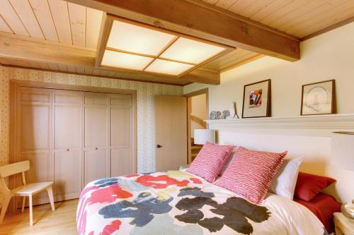 a bedroom with a bed and a skylight at Haystack Views Vacation Rental in Cannon Beach