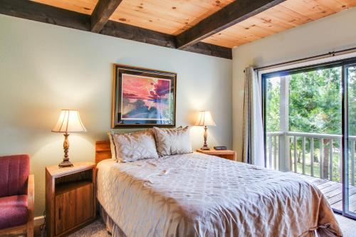 a bedroom with a bed and a large window at Nordic Retreat in Kings Beach