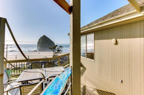 a balcony with chairs and a view of the beach at Haystack Views Vacation Rental in Cannon Beach