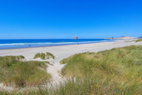 a beach with sand and the ocean in the background at Ocean's Reach in Pacific City
