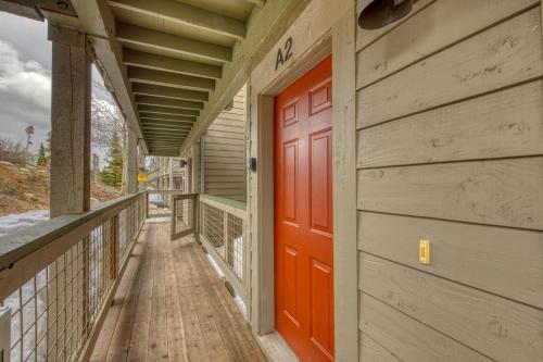 a red door on the side of a building at Wildernest Gore Trail Condo in Silverthorne