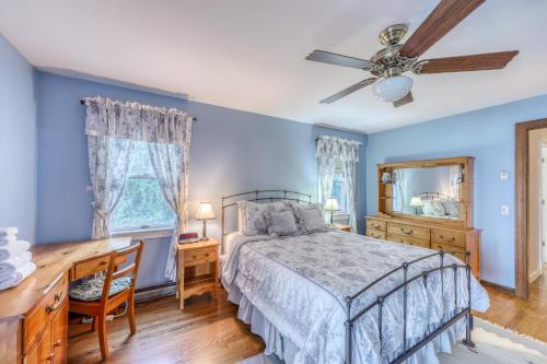 a bedroom with a bed and a desk and a ceiling fan at Home Away from Home + Studio in North Hero