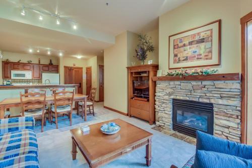 a living room with a fireplace and a dining room at Powderhorn Lodge 107: Columbine Suite in Solitude