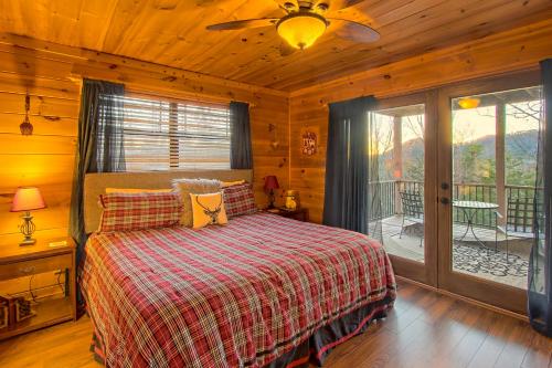 a bedroom with a bed and a ceiling fan at Soaring Eagle in Sautee Nacoochee
