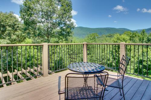 a table and two chairs on a wooden deck at Soaring Eagle in Sautee Nacoochee